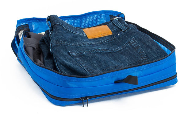 A change of clothes folded in a Island (blue) Aether Large Laundry Aeronaut 45 Packing Cube.